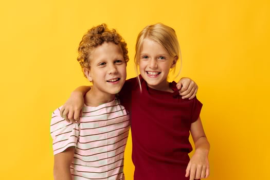 two joyful children casual wear games fun together isolated background photo