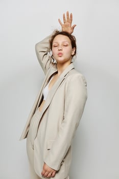 portrait of a young woman Clothes fitting elegant style suit fashion studio light background unaltered photo
