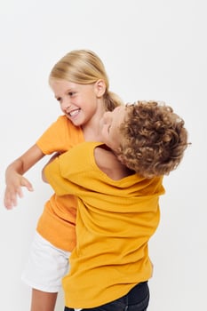 Boy and girl cuddling fashion childhood entertainment isolated background unaltered photo