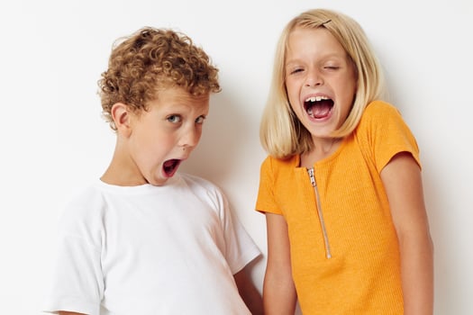 two joyful children casual clothes posing emotions studio isolated background unaltered photo