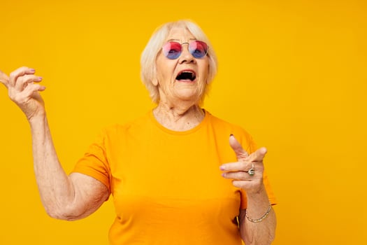 Photo of retired old lady happy lifestyle in yellow t-shirts cropped view