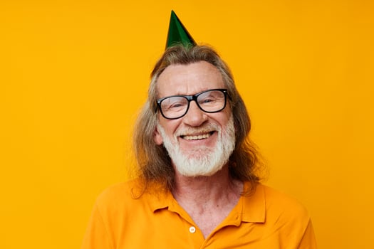 Portrait elderly man wearing glasses green cap on his head holiday emotions unaltered photo