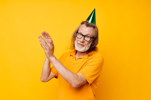 elderly man in a yellow t-shirt with a cap on his head fun monochrome shot photo