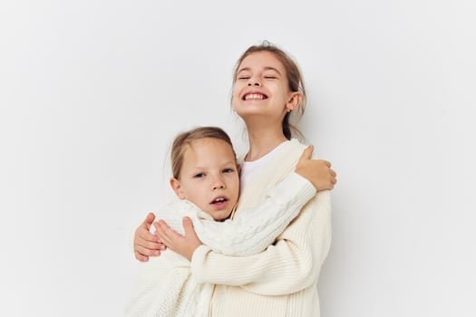 two little girls baby clothes posing light background photo