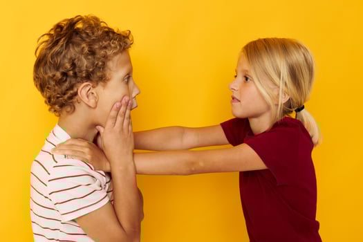 Boy and girl cuddling fashion childhood entertainment yellow background photo