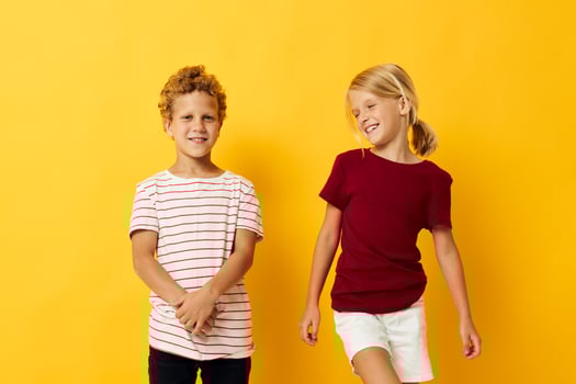 Cute stylish kids cuddling fashion childhood entertainment yellow background photo
