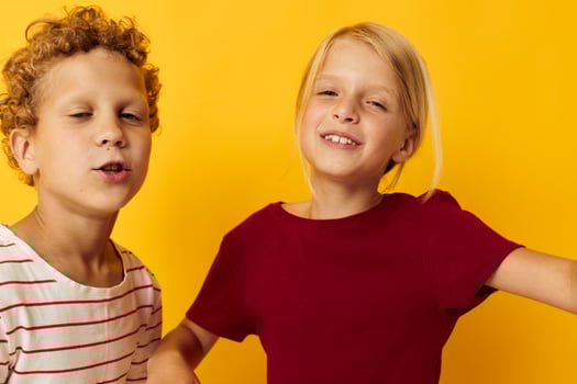 Small children cuddling fashion childhood entertainment on colored background photo