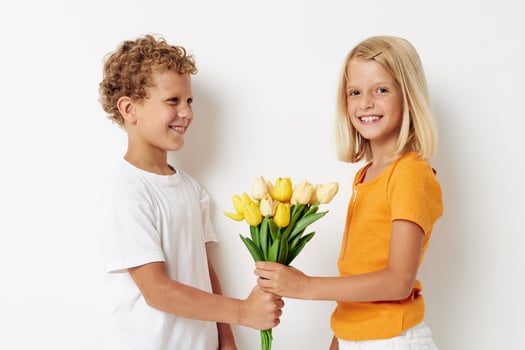 Small children fun birthday gift surprise bouquet of flowers isolated background unaltered photo