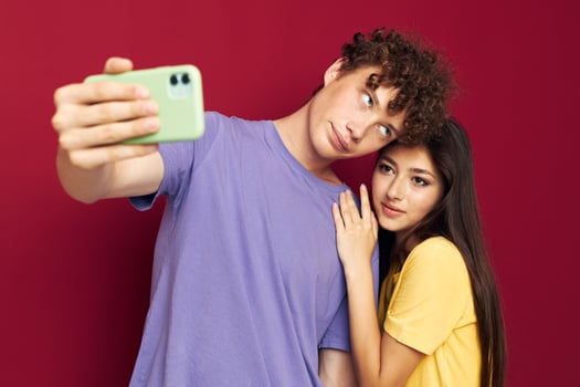 Man and woman in colorful T-shirts with a phone Youth style photo