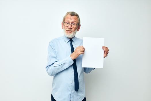 Portrait elderly man holding documents with a sheet of paper cropped view photo