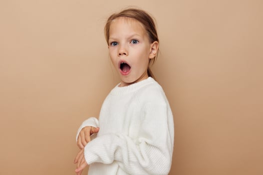 pretty young girl in white sweater posing hand gestures Lifestyle unaltered photo