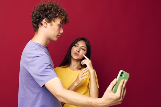 Man and woman in colorful T-shirts with a phone Youth style photo