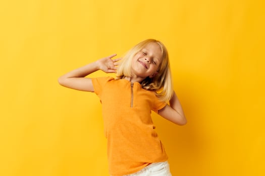 beautiful little girl in a yellow t-shirt smile posing studio childhood lifestyle unaltered photo