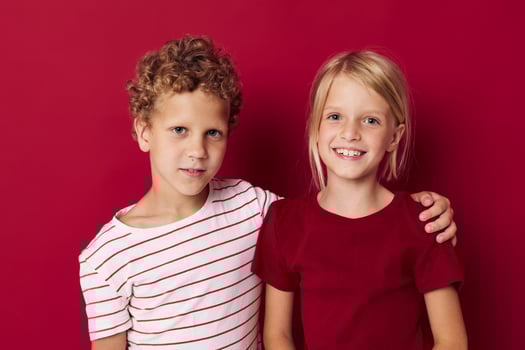 Cute stylish kids smiling and posing in casual clothes against isolated background photo