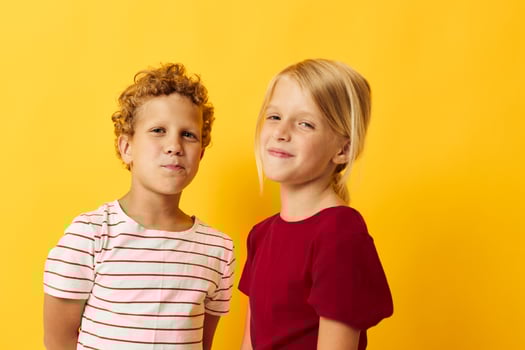 picture of positive boy and girl casual wear games fun together isolated background photo