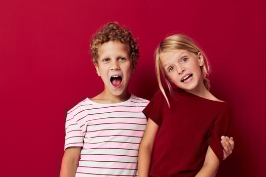 picture of positive boy and girl good mood standing next to posing isolated background photo