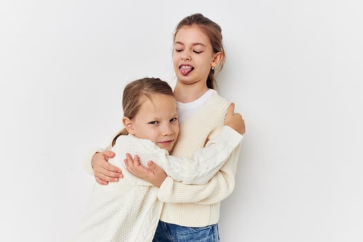 two little girls girlfriends posing light background photo