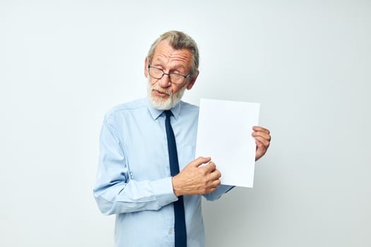Portrait elderly man holding documents with a sheet of paper cropped view photo