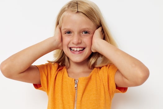 cheerful girl in a yellow t-shirt posing emotions light background photo