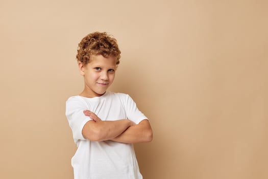 Cute little boy in a white t-shirt posing fun Lifestyle unaltered photo