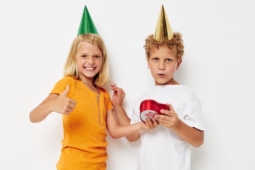 Cheerful boy with girl with hats gift birthday holiday photo