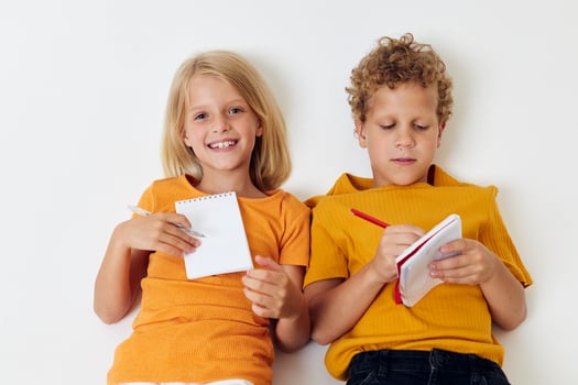 Cute stylish kids drawing fun games with notepad isolated background unaltered photo