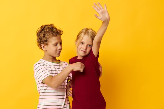 two joyful children standing side by side posing childhood emotions isolated background photo