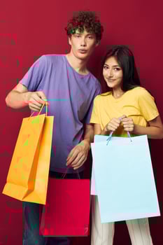 young boy and girl in colorful T-shirts with bags Shopping Lifestyle unaltered photo