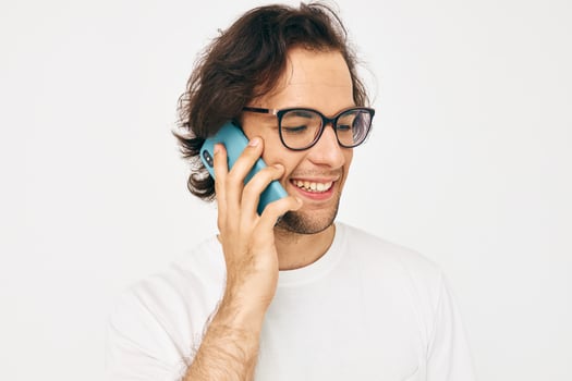 man in a white T-shirt communication by phone Lifestyle unaltered photo