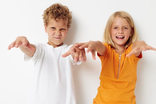 Boy and girl hand gestures fun childhood isolated background unaltered photo