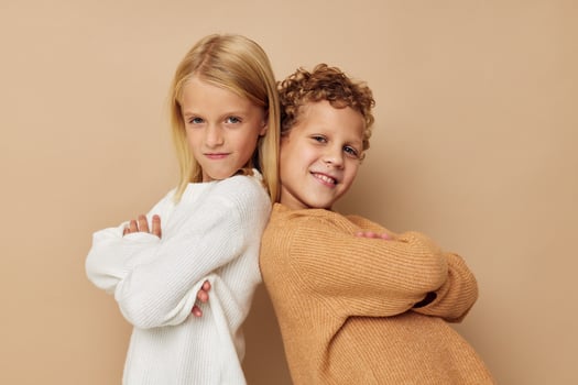 Portrait of cute children hug entertainment posing friendship beige background photo