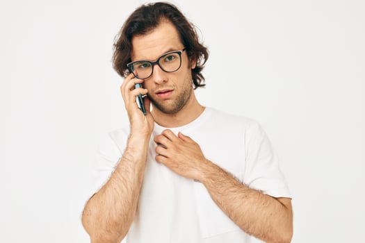 Cheerful man in a white T-shirt communication by phone isolated background photo