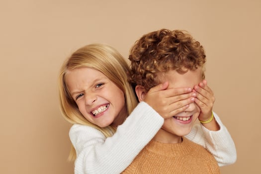 Cute stylish children hug entertainment posing friendship beige background photo