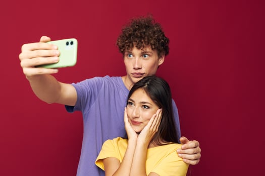 a young couple in colorful T-shirts with a phone Youth style photo