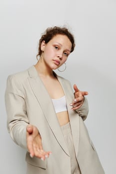 beautiful woman classic suit fashion posing fun light background unaltered photo