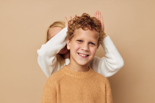 Boy and girl gesticulate with their hands together Lifestyle unaltered photo
