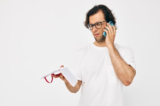 Cheerful man red notepad telephone communication Lifestyle unaltered photo