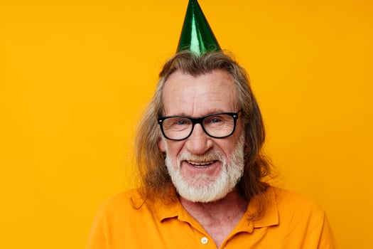 Portrait elderly man wearing glasses green cap on his head holiday emotions unaltered photo