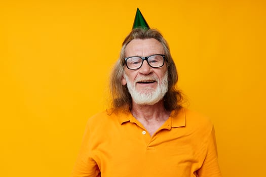 Senior grey-haired man wearing glasses green cap on his head holiday emotions monochrome shot photo