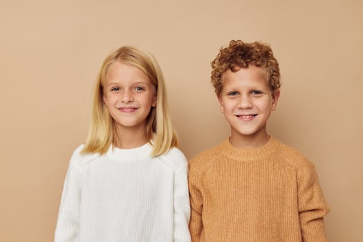 Boy and girl standing next to posing emotions Lifestyle unaltered photo