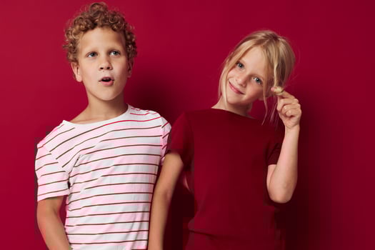picture of positive boy and girl good mood standing next to posing isolated background photo