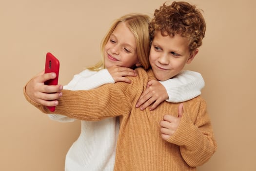 Little boy and girl hug entertainment selfie posing friendship childhood unaltered photo