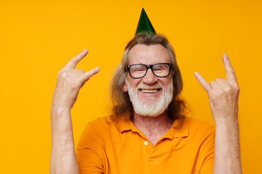 Senior grey-haired man wearing glasses green cap on his head holiday emotions monochrome shot photo