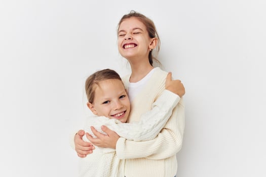 two little girls in sweaters posing friendship fun photo