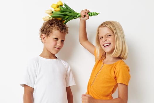 Portrait of cute children holiday friendship with a gift Yellow flowers lifestyle unaltered photo