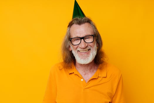 old man wearing glasses green cap on his head holiday emotions isolated background photo