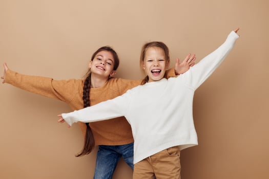 two cute little girls hug friendship childhood posing photo