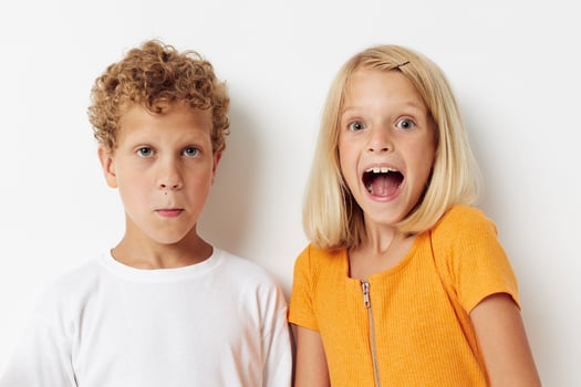 picture of positive boy and girl casual clothes posing emotions studio isolated background unaltered photo