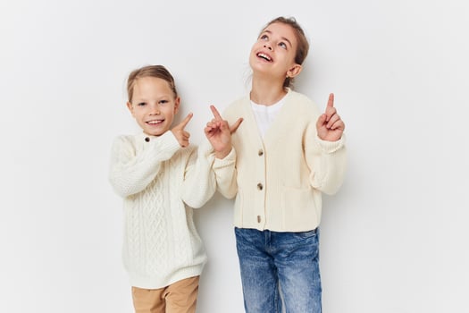 two little girls in sweaters posing friendship fun photo