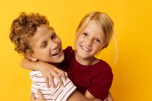 picture of positive boy and girl casual wear games fun together isolated background photo